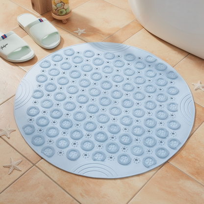 Blue round suction shower mat with drain holes on a tiled floor – ShowerNest