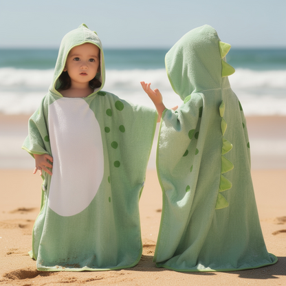 Two children in green dinosaur hooded towels at the beach – ShowerNest Australia