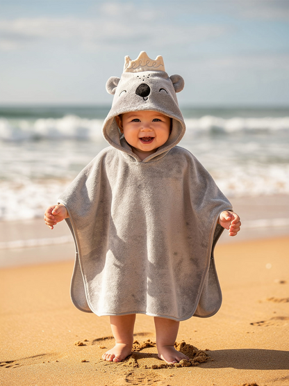 Toddler standing in the grey koala hooded towel poncho by the sea – ShowerNest Australia