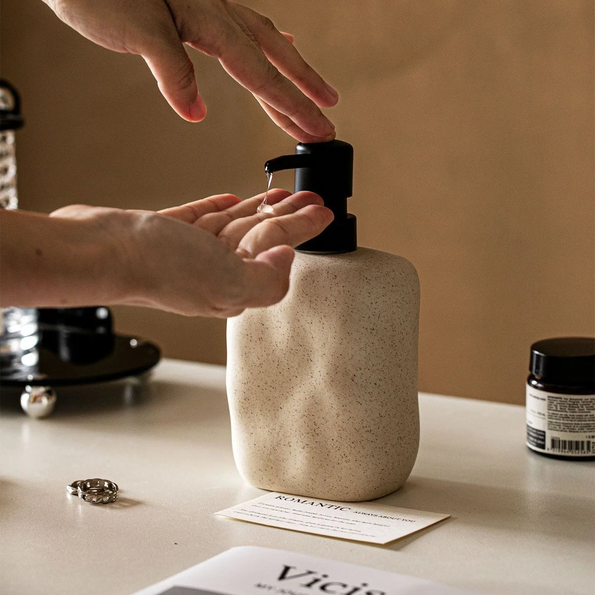 Cream ceramic soap dispenser close-up