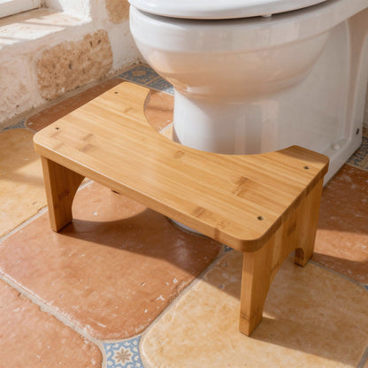 Bamboo squatting stool in front of a toilet on terracotta tiles