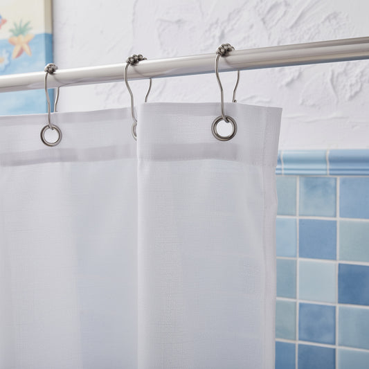 Metal shower curtain hooks holding a white curtain