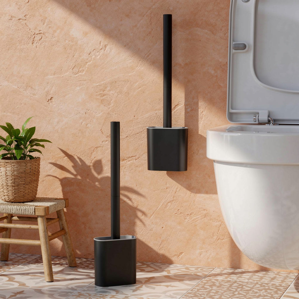 Black silicone toilet brush wall mounted on a terracotta wall