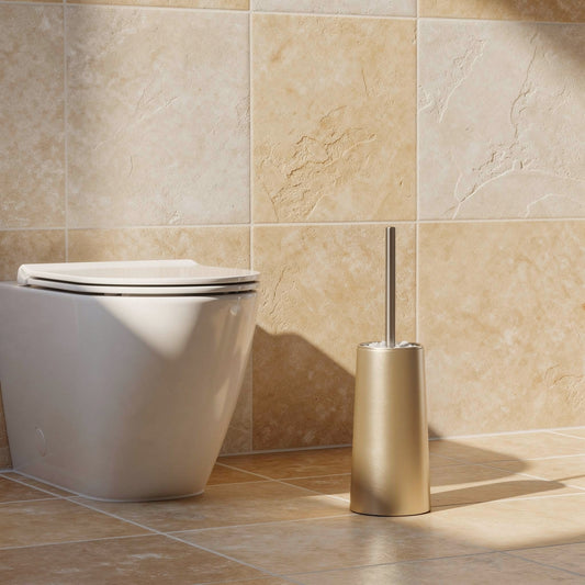 Champagne gold Nordic toilet brush and holder next to a toilet