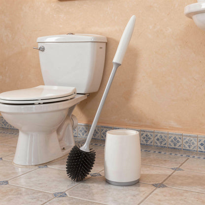 White silicone toilet brush and holder next to a toilet
